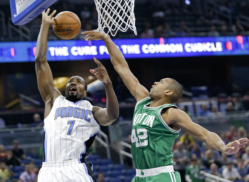 Orlando's Serge Ibaka is fouled as he goes to the basket against Boston's Al Horford in the first half Wednesday night in Orlando, Fla.