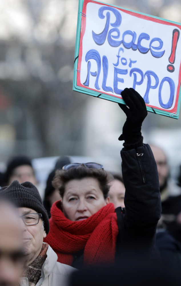 People demonstrate in front of the Russian embassy in Berlin on Wednesday to protest the bombing of Aleppo, Syria.