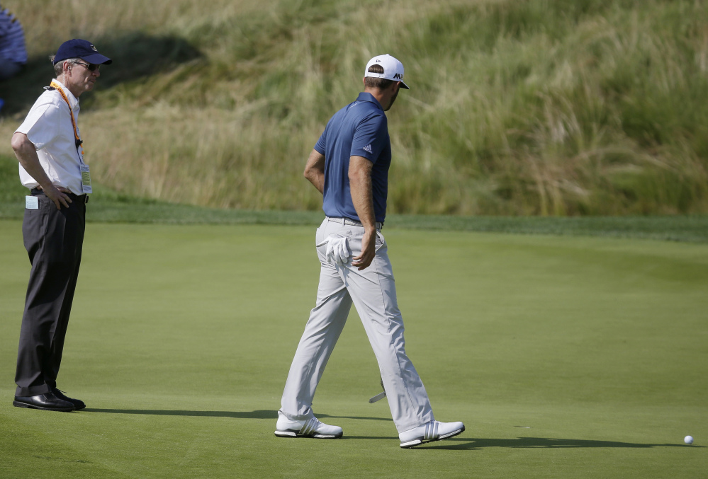 Dustin Johnson, right, was the victim of the old golf rule while challenging for the U.S. Open championship last June. His ball moved on the green without Johnson touching it, and when the round was over, he discovered he had been charged with a one-shot penalty. Johnson still won the tournament.