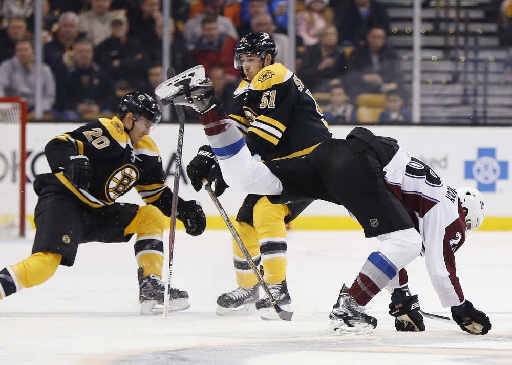 Colorado's Patrick Wiercioch trips up while battling Boston's Riley Nash, 20, and Ryan Spooner in the first period of Thursday night's game at Boston.