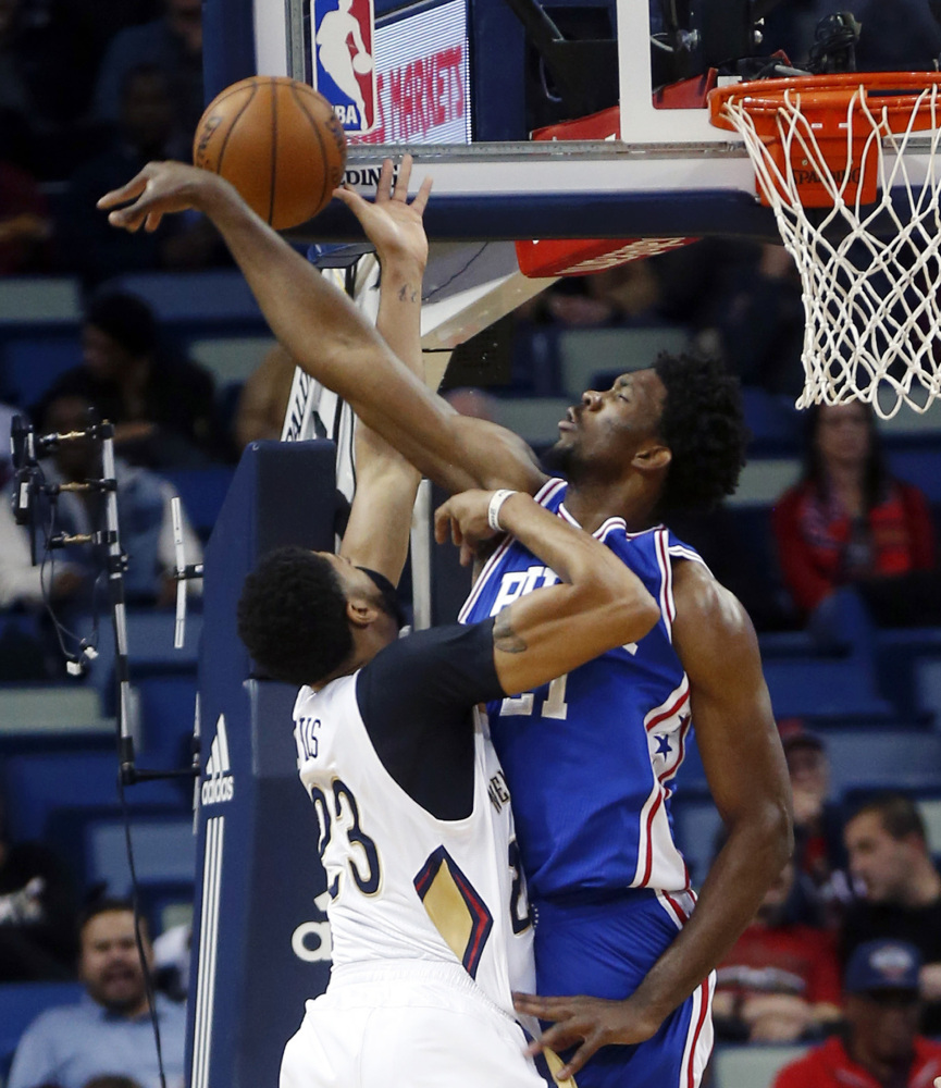 Joel Embiid, right, of the Philadelphia 76ers blocks a shot by Anthony Davis of the New Orleans Pelicans during the first half of the 76ers' 99-88 victory Thursday night.