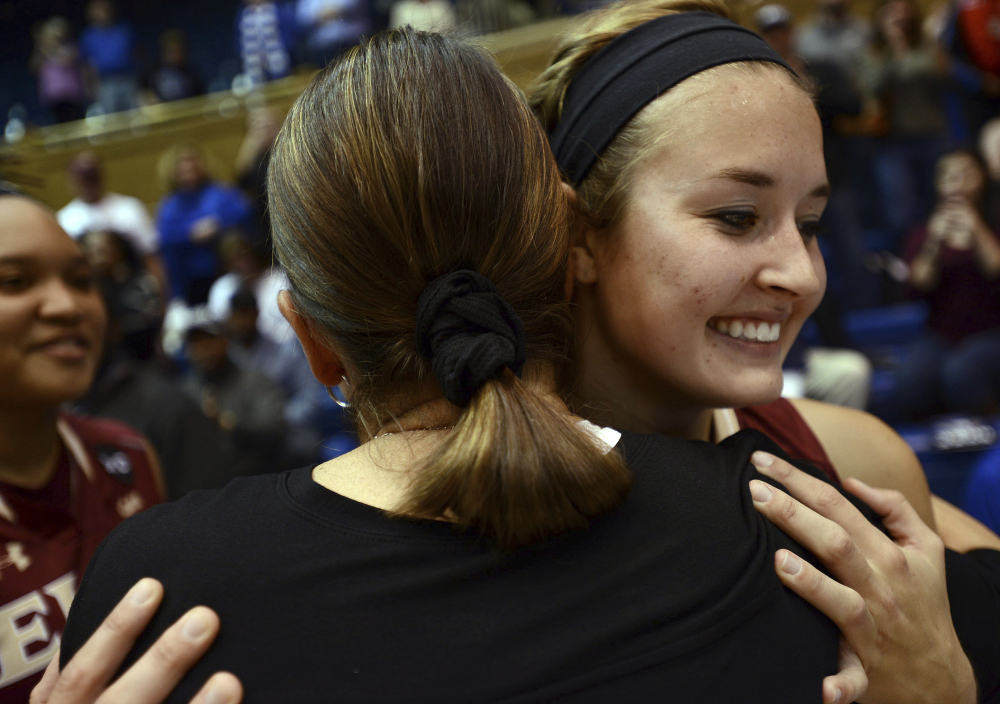 Elon's Maddie McCallie, right, hugs Joanne P. McCallie, her mother and Duke head coach, after Duke's 68-61 victory over the Phoenix on Thursday night in Durham, N.C.