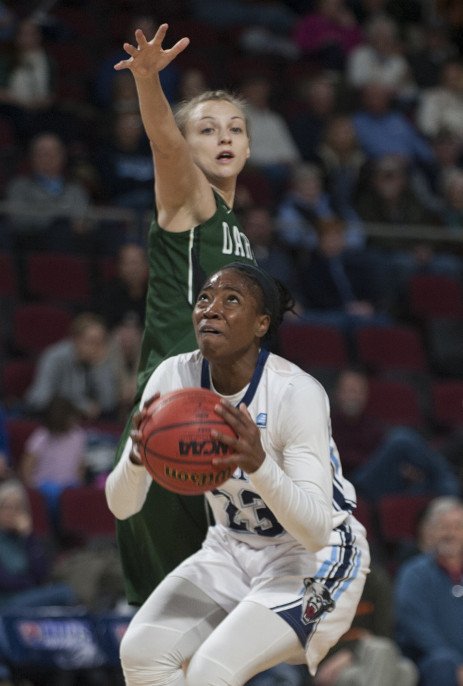 UMaine's Tanesha Sutton gets a shot of with pressure from Darmouth's Olivia Smith during first half Saturday at the Cross Insurance Center in Bangor. The Black Bears went on to a 60-55 win. (Kevin Bennett Photo)