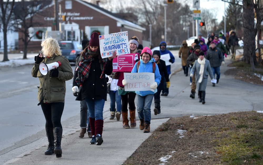 Protesters march down Spring Street in Waterville on Saturday as part of the Forward Together movement.