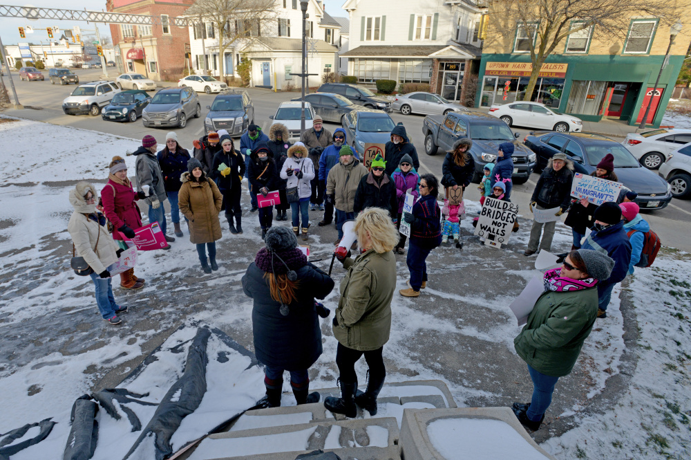 People gather outside Post Office Square for a Forward Together march on Main Street in Waterville on Saturday.