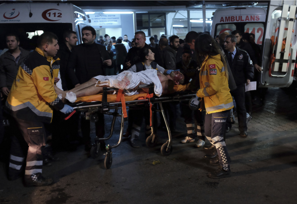 Rescue workers and medics carry a wounded person after the attacks in Istanbul late Saturday. 