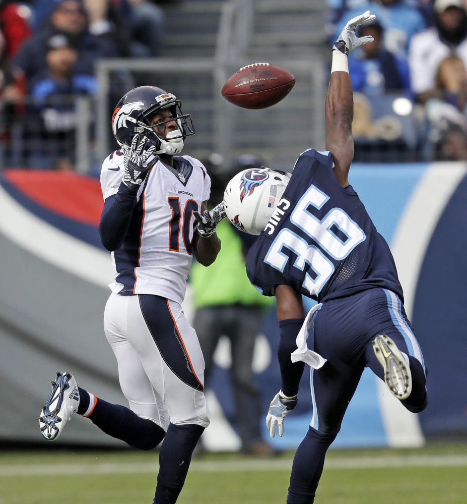 Titans cornerback LeShaun Sims, right, breaks up a pass intended for Denver's Emmanuel Sanders. Tennessee held off the Broncos' late comeback bid, earning a 13-10 victory.