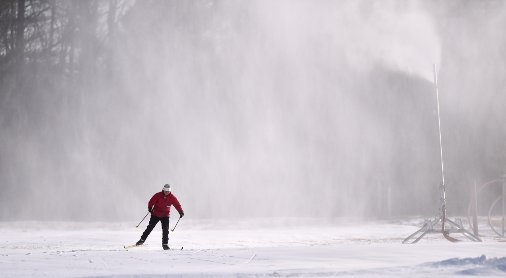 Caroline Mathes skis through the snow from the snow machines at Quarry Road Recreational Area in Waterville on Saturday.