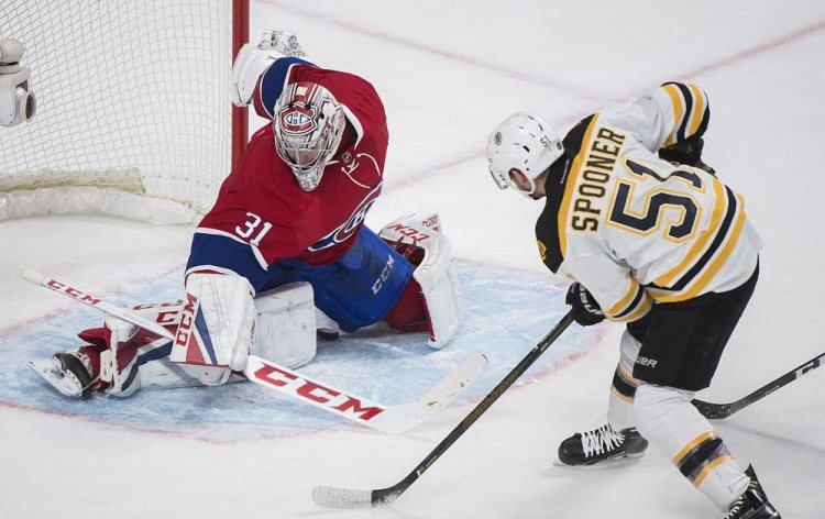Boston's Ryan Spooner scores the game winner in overtime on Canadiens goaltender Carey Price.