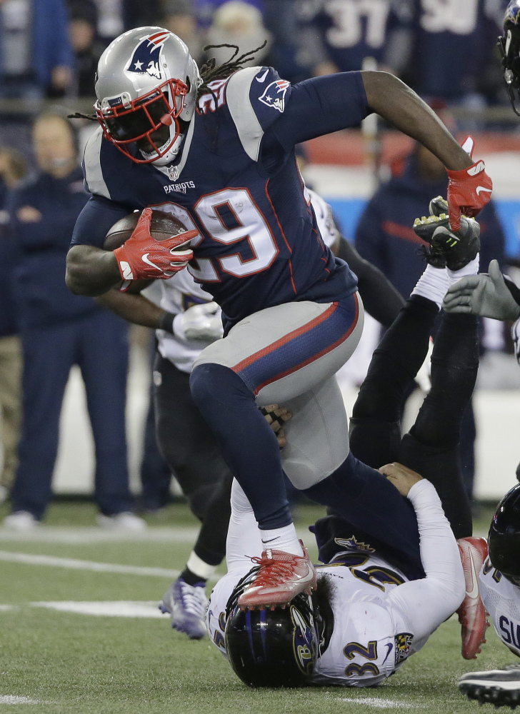 Patriots running back LeGarrette Blount runs over Ravens safety Eric Weddle in the second half of Monday, night's game in Foxborough. Blount rushed for 72 yards on 18 carries, passing 1,000 yards for the season.