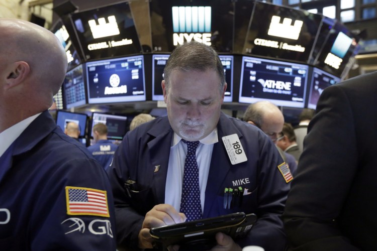 Trader Michael Conlon works on the floor of the New York Stock Exchange on Tuesday.