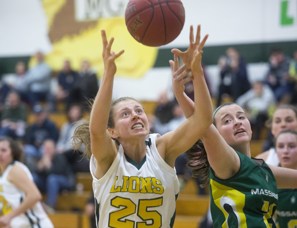 Maine Girls' Academy's Maddy Beaulieu, left, and Massabesic's Emily Stinson vie for a rebound in Tuesday night's girls' basketball game in Portland. MGA won, 49-27.