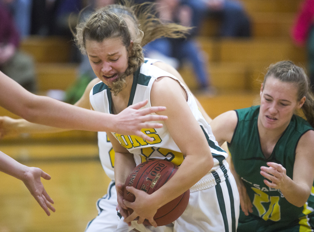 Maine Girls' Academy's Serena Mower fights to hold on to the ball. The Lions got their first win of the season as Jill Joyce had eight of her game-high 18 points in the third quarter.
