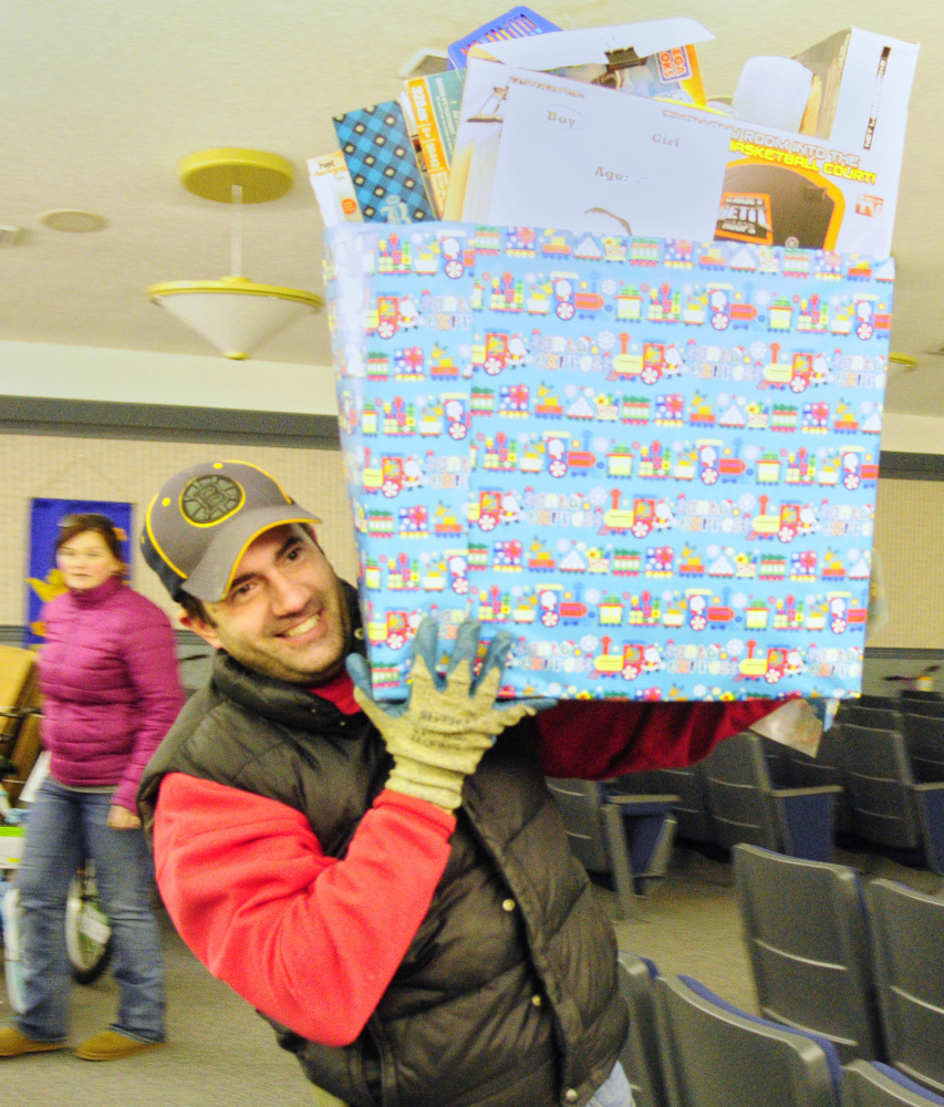 Greg Veilleux carries a box of toys donated by VA Maine Healthcare Systems-Togus staffers as he and five co-workers delivered them to the Salvation Army.
