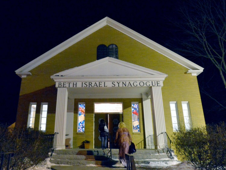 People gather at an interfaith service Friday evening at Beth Israel Congregation in Waterville in response to a swastika being painted on a rock at a city-owned park.
