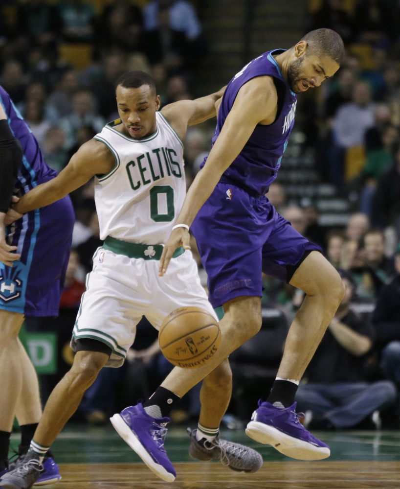 Charlotte guard Nicolas Batum dribbles while defended by Celtics guard Avery Bradley in the first quarter.
Associated Press/Elise Amendola