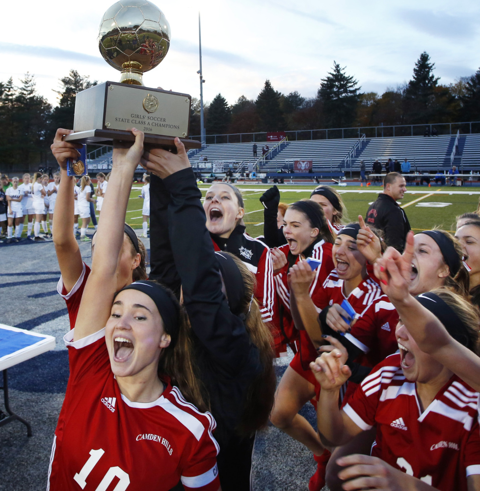 Charlotte Messer, left, and her Camden Hills teammates hoisted the Gold Ball after a 1-0 win over Gorham in the Class A state final, and it was Messer who scored the only goal, in overtime.