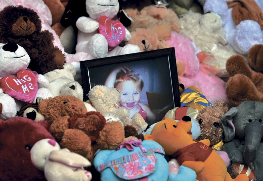 A picture of Ayla Reynolds sits among a shrine of teddy bears in December 2013 on the steps of the Waterville City Hall during a vigil for the missing toddler at Castonguay Square in downtown Waterville.