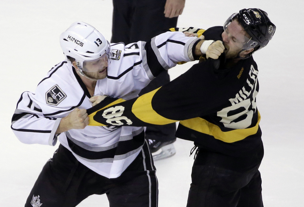 Kings left wing Kyle Clifford, left, and Bruins defenseman Kevan Miller fight in the first period Sunday in Boston.