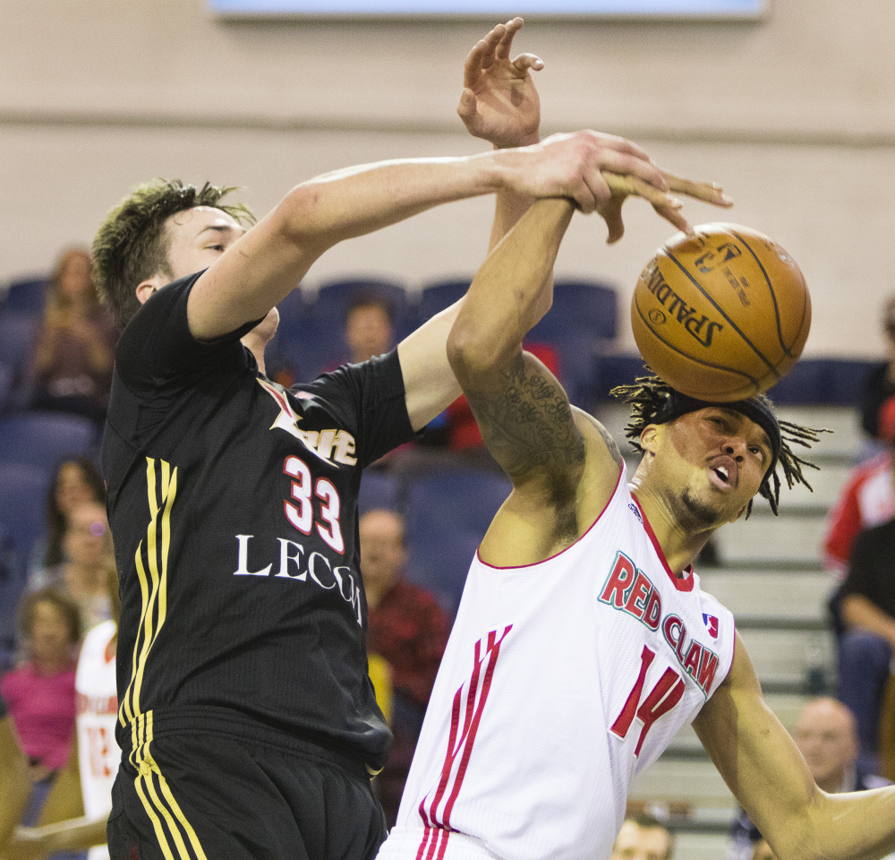 Erie BayHawks center Stephen Zimmerman, left, and Maine Red Claws guard Damion Lee fight for a rebound during Sunday's game at the Portland Expo. The Red Claws lost, 108-104.