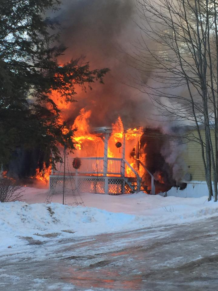 A home burns Tuesday morning at 15 Blue Rock Road in Monmouth.