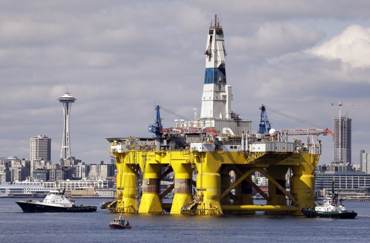 The oil drilling rig Polar Pioneer is towed toward a dock in Elliott Bay in Seattle in May 2015. The rig was the first of two drilling rigs Royal Dutch Shell was outfitting for Arctic oil exploration. President Obama ordered wide swaths of the Atlantic and Arctic oceans placed permanently off-limits for oil drilling.