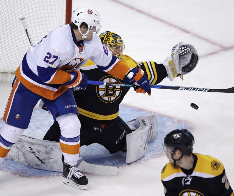 Islanders left wing Anders Lee tips the puck down in front of Bruins goalie Anton Khudobin in the third period of the Islanders' 4-2 win Tuesday in Boston.