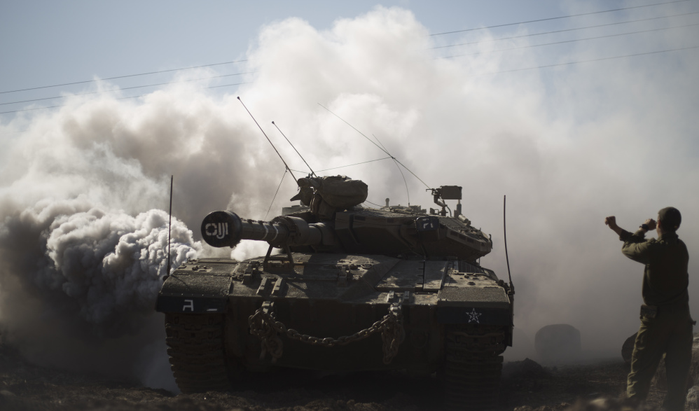 An Israeli soldier directs a tank in the Golan Heights last month. With Syria wracked by a civil war, Israel wants its control over the area to be recognized worldwide.