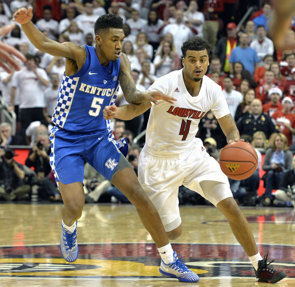 Louisville's Quentin Snider attempts to drive past the defense of Kentucky's Malik Monk during the second half of Wednesday's game in Louisville, Ky. Snider's career-high 22 points helped the Cardinals take a 73-70 victory in the in-state rivalry between two top-10 teams.