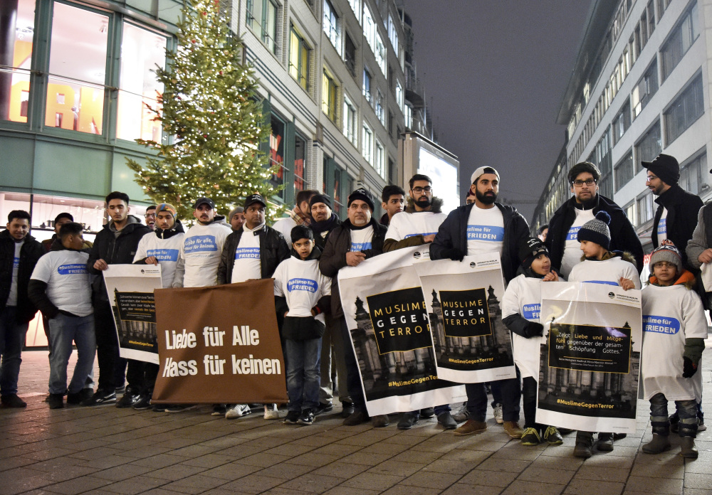 Muslims in Hamburg, Germany, commemorate the victims of Monday's terror attack in Berlin during a vigil Thursday night. Muslims are setting an example of peace with a candlelight vigil and a blood drive.