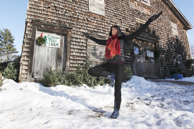 Elizabeth Burd, yoga teacher and seller of organic Christmas trees, standing in "tree pose" at her home in West Durham.