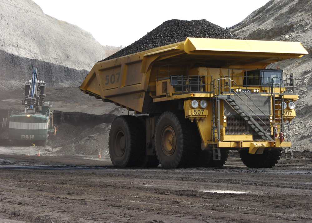 A truck hauls coal at Cloud Peak Energy's Spring Creek strip mine near Decker, Mont. President-elect Donald Trump's has promised to "put our miners back to work," and has been choosing fossil fuel-friendly Cabinet members.