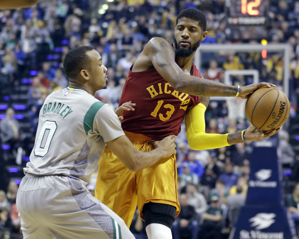 Indiana forward Paul George looks to pass around Boston's Avery Bradley in the first half Thursday's game in Indianapolis.