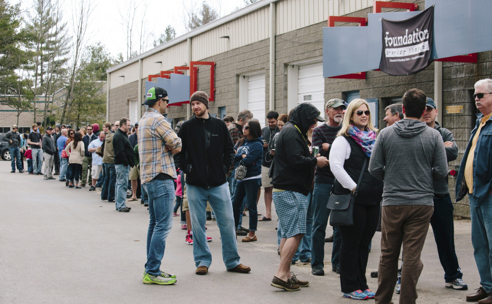 Customers throng outside 1 Industrial Way in Portland's Riverton neighborhood for a specialty beer release at Bissell Brothers brewery on a Saturday in April 2015. With craft-beer stalwart Allagash just across the street, the area has become a destination for "beer tourists." File photo/Whitney Hayward