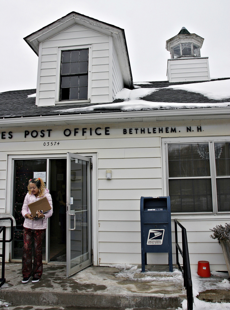 A patron leaves the post office in Bethlehem, N.H., on Tuesday. The tiny post office postmarked more than 58,000 pieces of holiday mail this year.