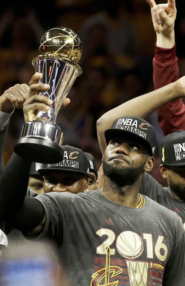 LeBron James of the Cleveland Cavaliers celebrates with teammates after capturing the NBA championship last June by defeating the Golden State Warriors 93-89 in Game 7 on the road.