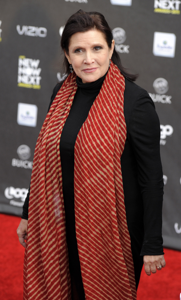Actress Carrie Fisher, shown in 2011, is reported to have suffered a heart attack on a flight from London to Los Angeles.
