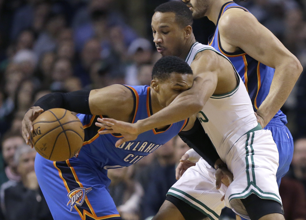 Oklahoma City Thunder guard Russell Westbrook, left, drives while being defended by Boston Celtics guard Avery Bradley during the first half of the Thunder's 117-112 win Friday in Boston.
