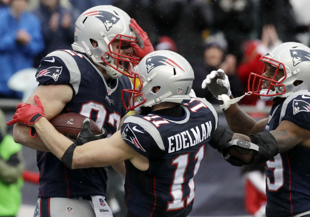 New England Patriots tight end Matt Lengel, left, celebrates his touchdown catch with Julian Edelman, center, and Malcolm Mitchell during the first half against the New York Jets on Saturday in Foxborough, Mass. (Associated Press/Charles Krupa)