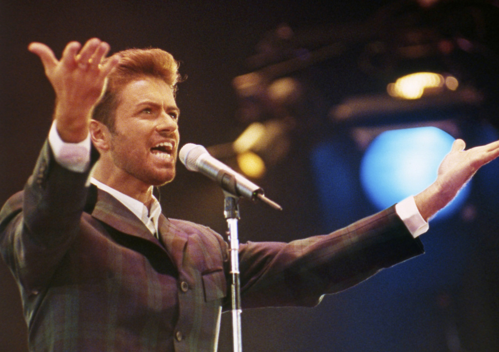 George Michael performs at the Concert of Hope to mark World AIDS Day at London's Wembley Arena in 1993. The singer who started out with the 80s group Wham! died Dec. 25 at age 53.
