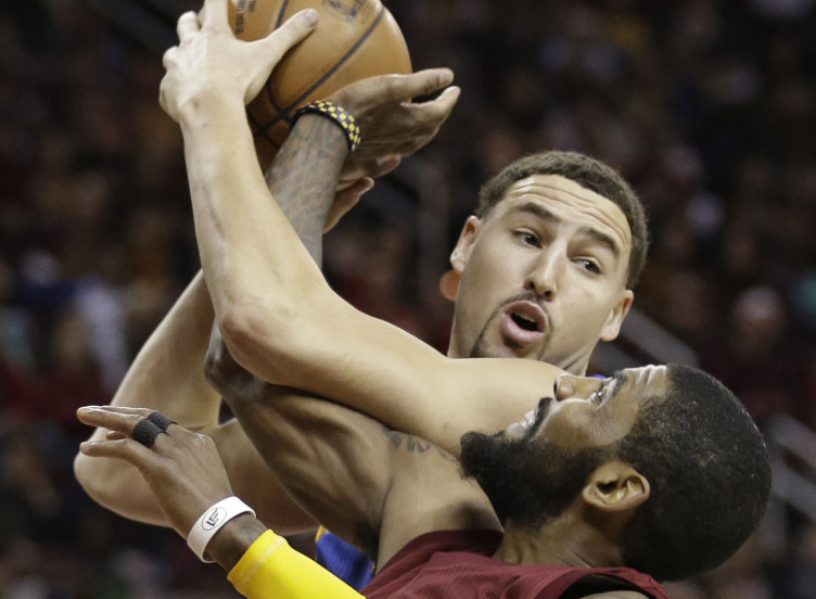 Golden State's Klay Thompson looks to pass over Cleveland's Kyrie Irving during their Christmas Day matchup. Irving hit a jumper with 3.4 seconds left to give the Cavaliers a 109-108 win.