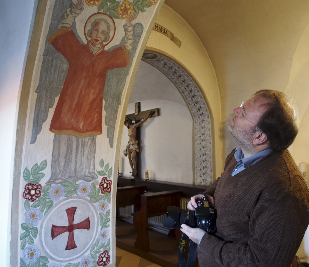 Historian Volker Schier views a mural in the abbey in Altomuenster, Germany. He estimates that the abbey's library holds around 80 percent of the order's books.
