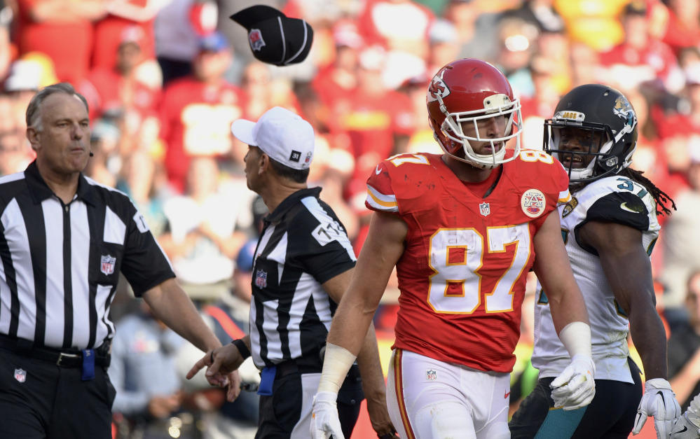 Field judge Mike Weatherford, left, throws his cap toward Kansas City Chiefs tight end Travis Kelce after Kelce, who was ejected for unsportsmanlike conduct, threw a towel in his direction during a Nov. 6 game against the Jacksonville Jaguars.