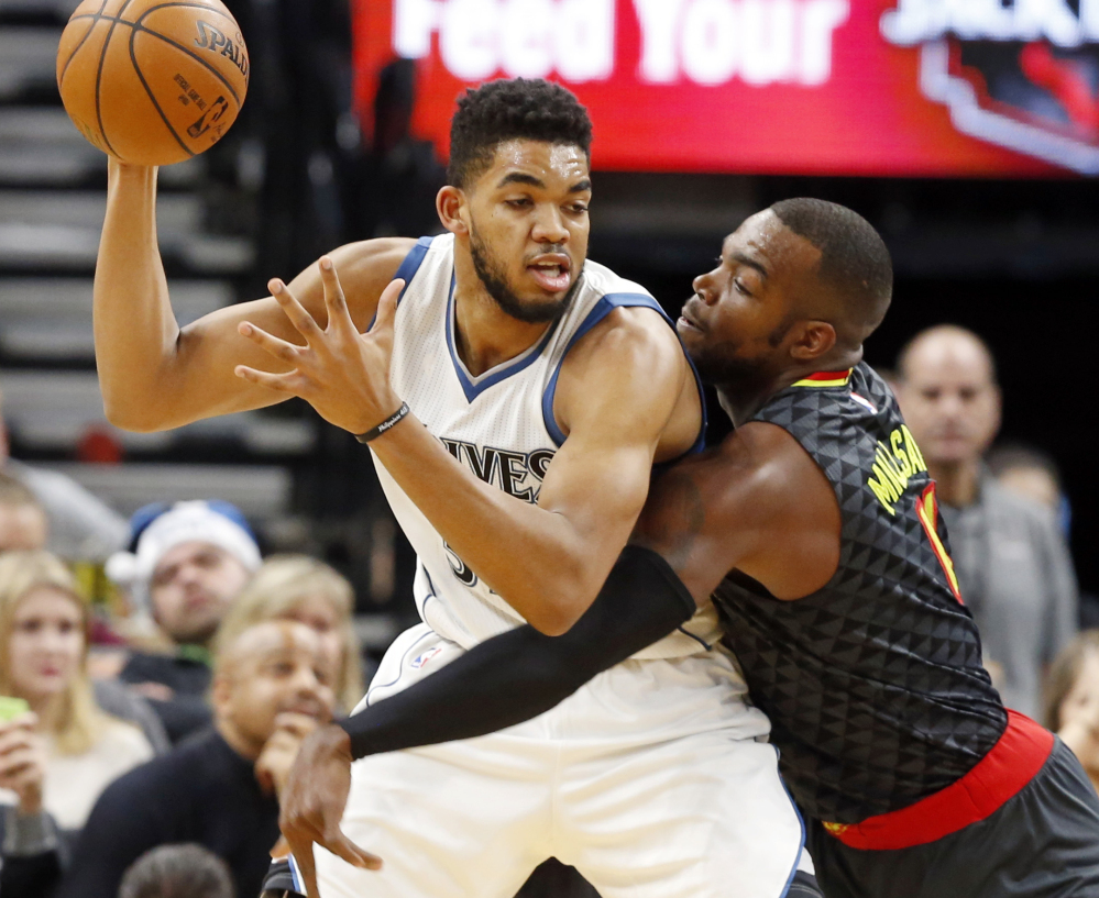 Minnesota's Karl-Anthony Towns, left, looks to make a move against Atlanta's Paul Millsap during the Timberwolves' 104-90 win Monday in Minneapolis.