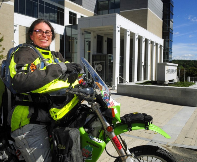 Carmel Rubin sits on her Kawasaki outside the Capital Judicial Center on Sept. 16 in Augusta. She'd just left her going-away party and was ready to start 14 months of traveling.