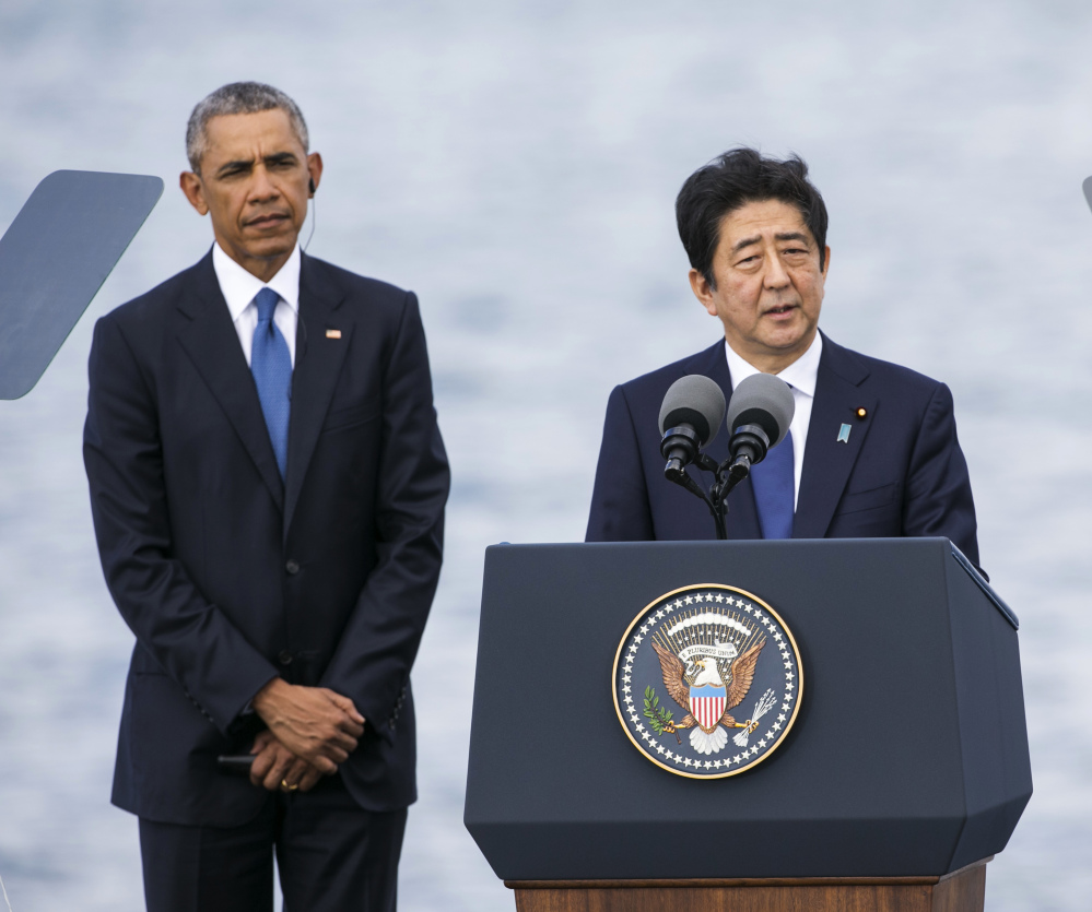 Japanese Prime Minister Shinzo Abe appears with U.S. President Obama at Joint Base Pearl Harbor Hickam on Tuesday in Honolulu. Abe and Obama made a historic pilgrimage Tuesday to the site where the devastating surprise attack sent America marching into World War II.