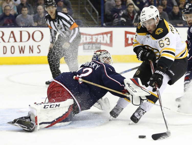 Columbus goalie Sergei Bobrovsky makes a save against the Bruins' Brad Marchand in the first period of the Blue Jackets' 4-3 win Tuesday night.