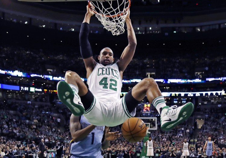 The Celtics' Al Horford hangs from the rim after a dunk against the Grizzlies in the first quarter Tuesday night in Boston.