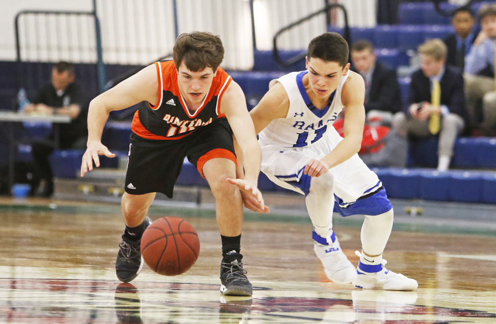 Carter Edgerton of Biddeford, left, and Tripp Bush of Kennebunk chase after a loose ball Tuesday during the first half of their SMAA game at the Portland Expo. Biddeford came away with a 76-46 victory.