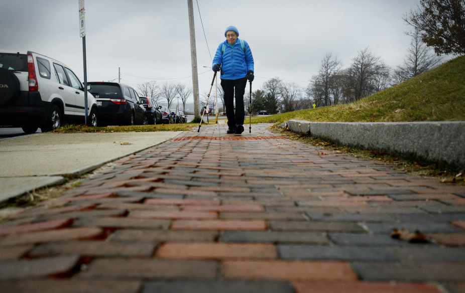 Seen using trekking poles in Portland in 2015, Bobbi Keppel is an advocate for pedestrians and elders. Senior housing and other programs help to keep older Mainers connected to others.